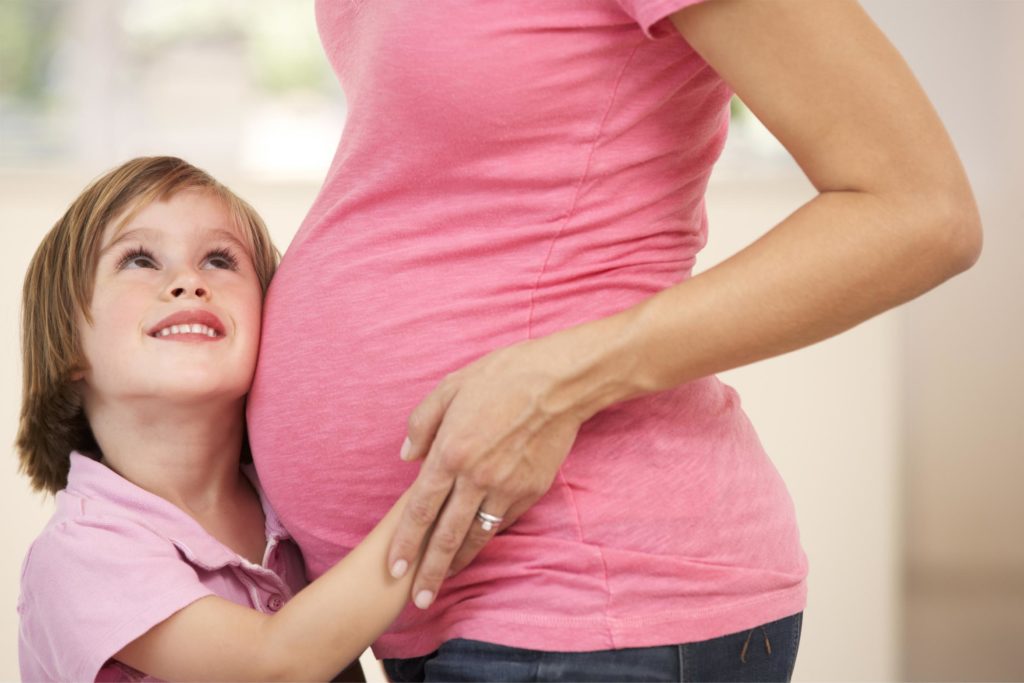 Pregnant woman with daughter